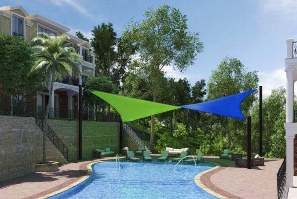 Weather-resistant, in-ground mounted shade sail structure ideal for coastal installations.