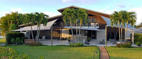 Versatile in-ground sail shade with 16 fabric color choices for outdoor elegance.